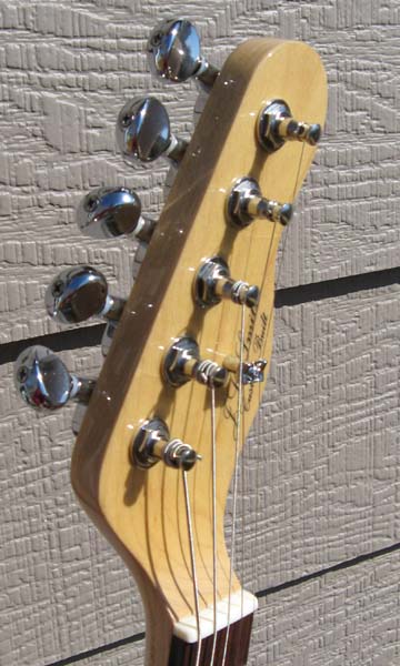 Extreme headstock angle curve that pulls the lowest string back with a satisfying tension
