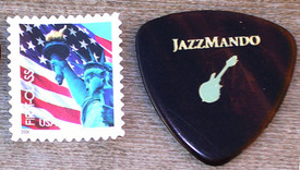 Left US Postage Stamp, Right JazzMando ProPlec Pick